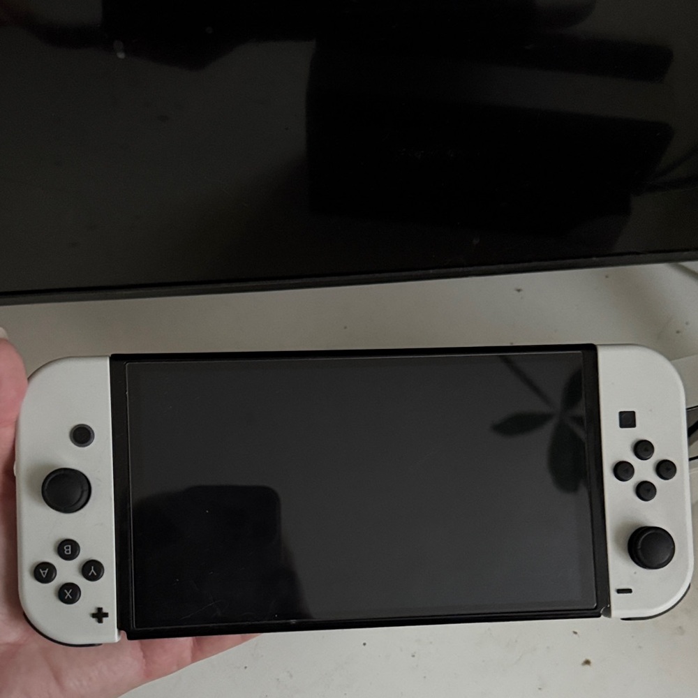 Nintendo Switch OLED
 White Handheld Gaming Console with Dual Analog Controls